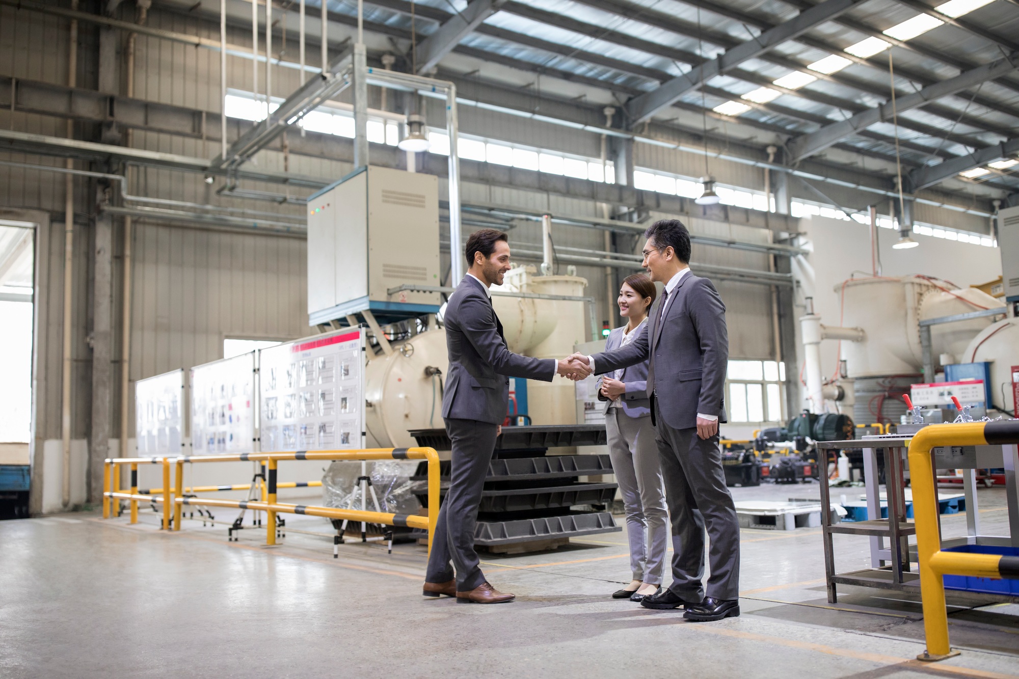Business people shaking hands in the factory